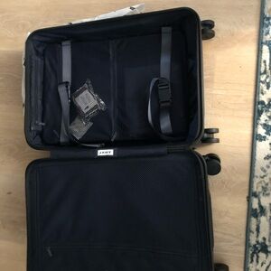 AWAY suit case- BIGGER size for carry on . BRAND NEW WITH TAGS AND ORIGINAL BOX